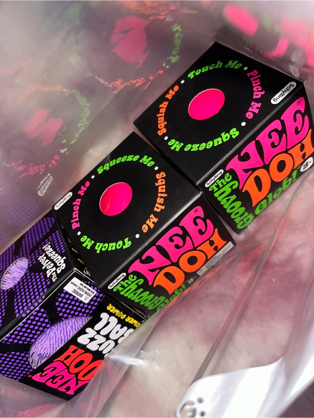 2 NeeDoh Groovy Glow Stress Ball and 1 fuzz ball